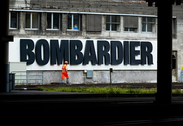 Bombardier quarterly core revenue almost halves