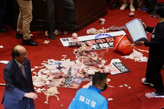 Fists and pig guts fly in Taiwan parliament debate on U.S. pork