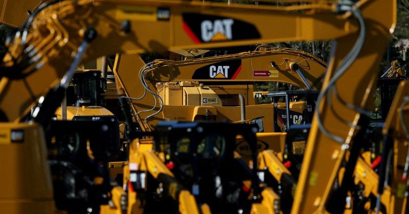 Caterpillar profit slides as costs and forex squeeze margins, shares down