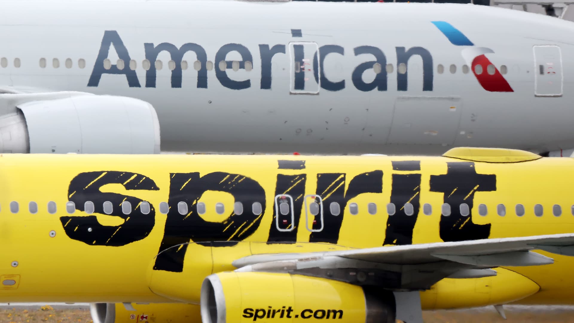 American Airlines, Spirit cut summer profit forecast on costs