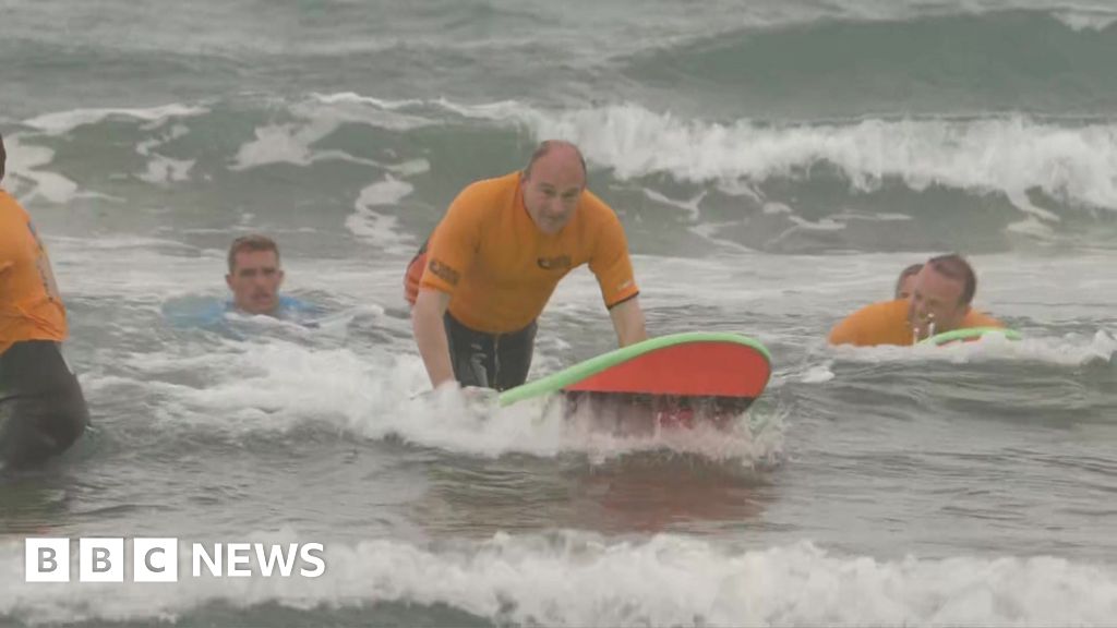 Sir Ed Davey makes a splash surfing in Cornwall